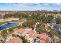 Beautiful aerial view of the property with a red tile roof near the golf course at 7566 Spanish Bay Dr, Las Vegas, NV 89113