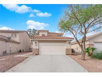 Inviting two-story home with a well-maintained front yard and a two-car garage at 7961 Willow Pines Pl, Las Vegas, NV 89143