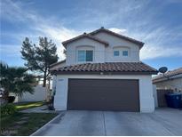 Charming two-story home with a well-maintained lawn and a two-car garage in a residential neighborhood at 8396 Yamhill St, Las Vegas, NV 89123