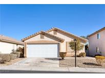 Charming single-story home with a well-maintained front yard and two-car garage with white door at 8936 Medicine Wheel Ave, Las Vegas, NV 89143