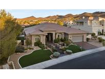 Elegant single-story home features desert landscaping, a tile roof, and an attached two-car garage at 10 Greely Club Trl, Henderson, NV 89052