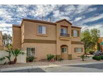 Inviting two-story home featuring desert landscaping, a balcony, and an attractive stucco facade at 11159 African Sunset St, Henderson, NV 89052