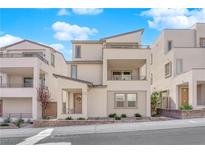 Stylish, modern home boasts a neutral color scheme, multiple balconies and beautiful landscaping at 11563 Earth Stone Ave, Las Vegas, NV 89138