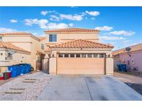 Charming two-story home showcasing a neutral color palette, tile roof and attached two-car garage at 1312 Pacific Terrace Dr, Las Vegas, NV 89128
