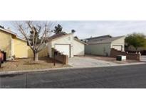 Residential street view with single-story homes, driveways, and minimal landscaping at 2021 San Simeon St, Las Vegas, NV 89108