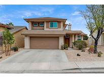Inviting two-story home features a well-manicured yard and attached two-car garage at 2061 Smoketree Village Cir, Henderson, NV 89012