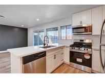 Bright kitchen featuring white cabinetry, stainless steel appliances, and a sleek quartz countertop at 2567 Paradise Village Way, Las Vegas, NV 89120