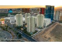 Striking aerial view of high-rise condos with city skyline and desert mountains in the background at 2857 Paradise Rd # 601, Las Vegas, NV 89109