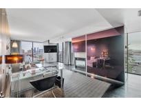 Bright living room featuring modern decor, a sleek fireplace, and city views at 4381 West Flamingo Rd # 8322, Las Vegas, NV 89103