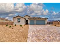 Charming single-story home with a desert landscape and a paved driveway leading to a two-car garage at 4680 Peppertree St, Pahrump, NV 89061