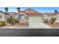 Charming single-story home featuring a well-maintained lawn, desert landscaping and a two-car garage with a neutral colored door at 514 Regal Robin Way, North Las Vegas, NV 89084