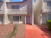 Charming two-story townhome featuring a well-maintained front yard and inviting entrance, perfect for comfortable living at 5383 Mountain Vista St # 20, Las Vegas, NV 89120
