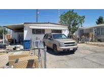 Exterior of home with carport and tan SUV parked out front at 5580 E Carey Ave, Las Vegas, NV 89156