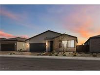 Beautiful single-story home featuring a two-car garage and desert landscaping at dusk at 6726 N Palmer Estates St, North Las Vegas, NV 89086