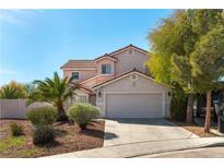 Charming two-story home with a spacious two-car garage and desert landscaping for easy maintenance at 1011 Pearl Marble Ave, North Las Vegas, NV 89081