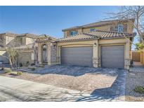 Charming two-story home featuring a tile roof, three-car garage, and brick-paved driveway at 10173 Skye Saddle Ave, Las Vegas, NV 89166
