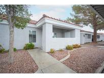 Charming single-story home with a stucco exterior, a red tile roof, and a rock garden at 1704 N Jones Blvd, Las Vegas, NV 89108