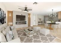 Bright living room with modern fireplace and media center, plus stylish decor at 2105 Cardigan Ave, North Las Vegas, NV 89032