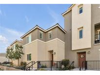 Charming townhome featuring a two-story design, neutral color palette, and inviting entryway at 2846 Cerulean Stars Ln # 1, Las Vegas, NV 89183