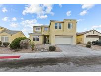 Two-story home showcasing a neutral color palette, a two-car garage, and low maintenance landscaping at 3009 Chilly Nights Ave, North Las Vegas, NV 89031