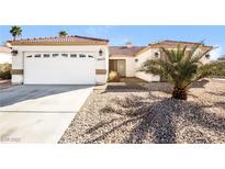 Charming single-story home with desert landscaping, a two-car garage and a red tile roof at 3450 Shonna Way, North Las Vegas, NV 89032