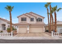 Charming two-story home featuring a two-car garage and desert landscaping with beautiful palm trees at 3609 Twinbreeze St, Las Vegas, NV 89129
