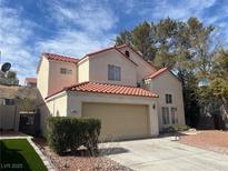 Two-story home with a red tile roof, attached two-car garage and desert landscaping at 417 Raindance Dr, Henderson, NV 89014