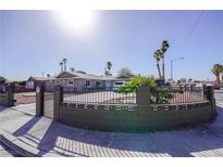 Charming single-story home with a unique brick fence and lush landscaping at 5433 Londonderry St, Las Vegas, NV 89119