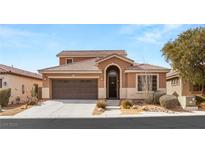 Inviting front exterior of home with a desert landscape and covered porch, plus two-car garage at 5809 Sagamore Canyon St, North Las Vegas, NV 89081