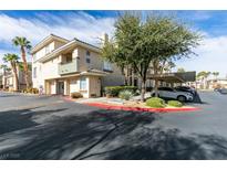 Inviting condo exterior with well-maintained landscaping, mature trees, and convenient covered parking at 7163 S Durango Dr # 302, Las Vegas, NV 89113