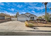 Charming single-story home featuring a xeriscaped front yard and an attached two-car garage at 806 Fireweed Dr, Henderson, NV 89002