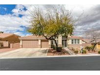 Charming single-story home featuring a well-manicured front yard and a three-car garage at 8346 Christinas Cove Ave, Las Vegas, NV 89131