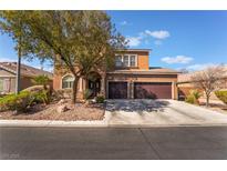 Two-story home with a landscaped front yard and two-car garage on a sunny day at 8817 Adobe Grande St, Las Vegas, NV 89131