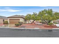 Single story home showcasing desert landscaping with mature trees and neutral tones at 2526 Evansville Ave, Henderson, NV 89052
