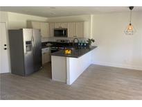 Bright kitchen with stainless steel appliances, modern countertops and flooring at 2621 Adelante Ave # 102, Las Vegas, NV 89106