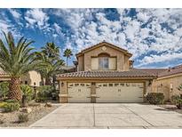 Two-story stucco home featuring a tile roof, desert landscaping, and a spacious two-car garage at 28 Birkdale Dr, Henderson, NV 89074