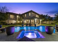 Inviting backyard pool and spa with covered patio, perfect for relaxing evenings and outdoor entertaining at 320 Lorelei Rock St, Las Vegas, NV 89138