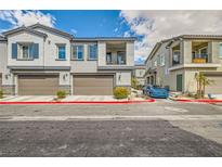 Charming townhomes featuring private garages and cozy balconies against a beautiful sky at 7308 N Decatur Blvd # 1, Las Vegas, NV 89131