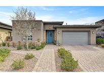 Stunning single-story home with a well-manicured front yard, stone accents, and a charming blue entry door at 10001 Regency Square Ave, Las Vegas, NV 89148