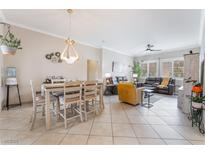 Open-concept living and dining area featuring tile flooring, stylish furniture, and ample natural light at 10508 Snyder Ave, Las Vegas, NV 89134
