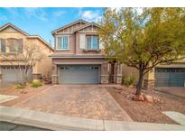 Charming two-story home with a paver driveway and a well-manicured front yard, perfect for Gathering living at 10548 Nantucket Ridge Ave, Las Vegas, NV 89166