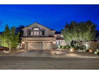 Charming two-story home showcasing a three-car garage, mature trees, and manicured landscaping at 2236 Midvale Ter, Henderson, NV 89074