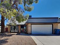 Charming single-story home with a two-car garage, landscaped front yard, and welcoming entrance at 4756 Lake Pl, Las Vegas, NV 89147