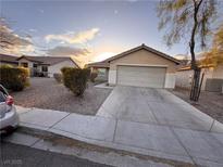 Charming single-story home featuring a two-car garage and a well-maintained front yard with desert landscaping at 4841 Crystal Sword St, North Las Vegas, NV 89031