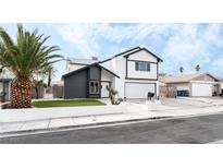 Charming renovated two-story home with a modern black and white exterior and a well-manicured front yard at 6407 Spring Meadow Dr, Las Vegas, NV 89103