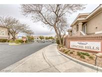Exterior view of the Apache Hills community entrance with well-maintained landscaping and signage at 9330 W Maule Ave # 225, Las Vegas, NV 89148