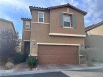 Charming two-story home features a symmetrical facade, attached garage, and low-maintenance landscaping at 9445 Sweetwood Ave, Las Vegas, NV 89149