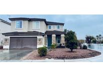 Two-story home featuring a stone-accented facade, a two-car garage, and a well-maintained front yard landscape at 9670 Gentle Spirit Dr, Las Vegas, NV 89148