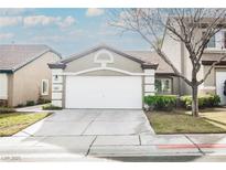 Charming single-Gathering home featuring a two-car garage, desert landscaping, and neutral color palette at 10341 Birch Bluff Ln, Las Vegas, NV 89145