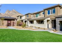 Beautiful two-story townhouse featuring a well-maintained lawn and mountain views at 11439 Peak Landing Ave, Las Vegas, NV 89138